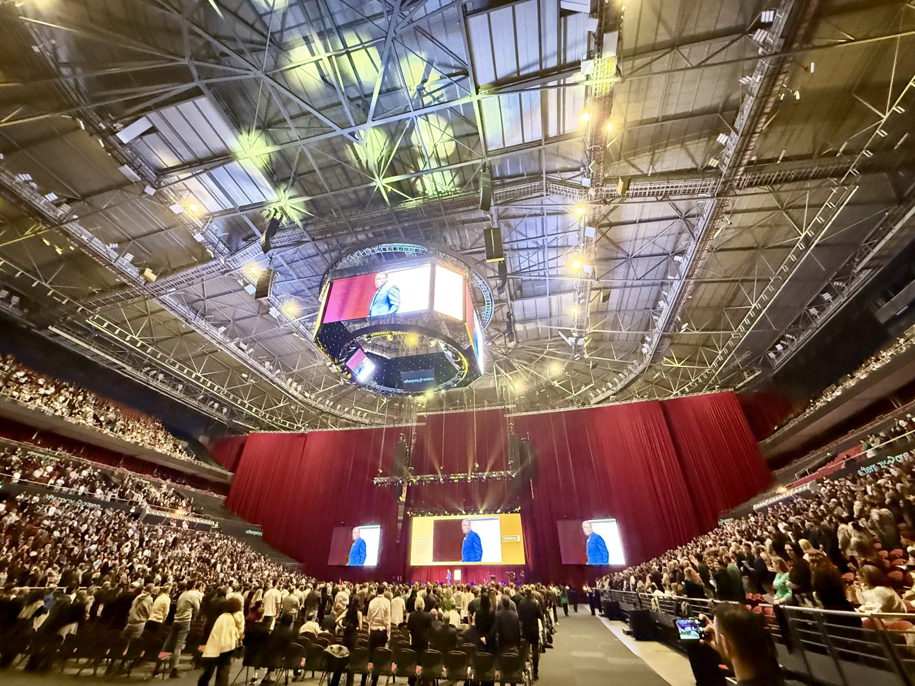 Crowd, central stage and overhead screen inside the arena at Fortuna One Global Summit